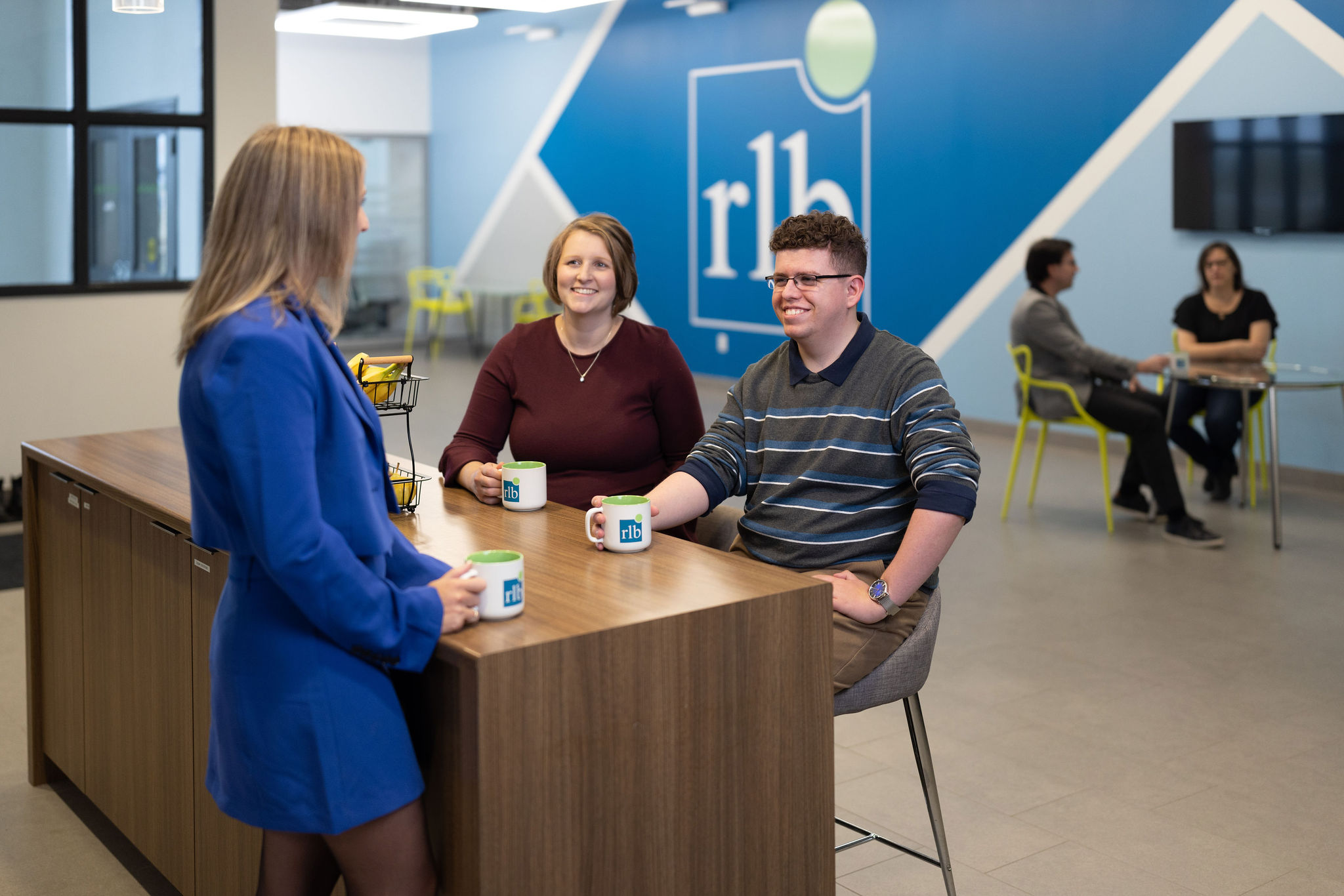 Group of people sitting at coffee station having a conversation