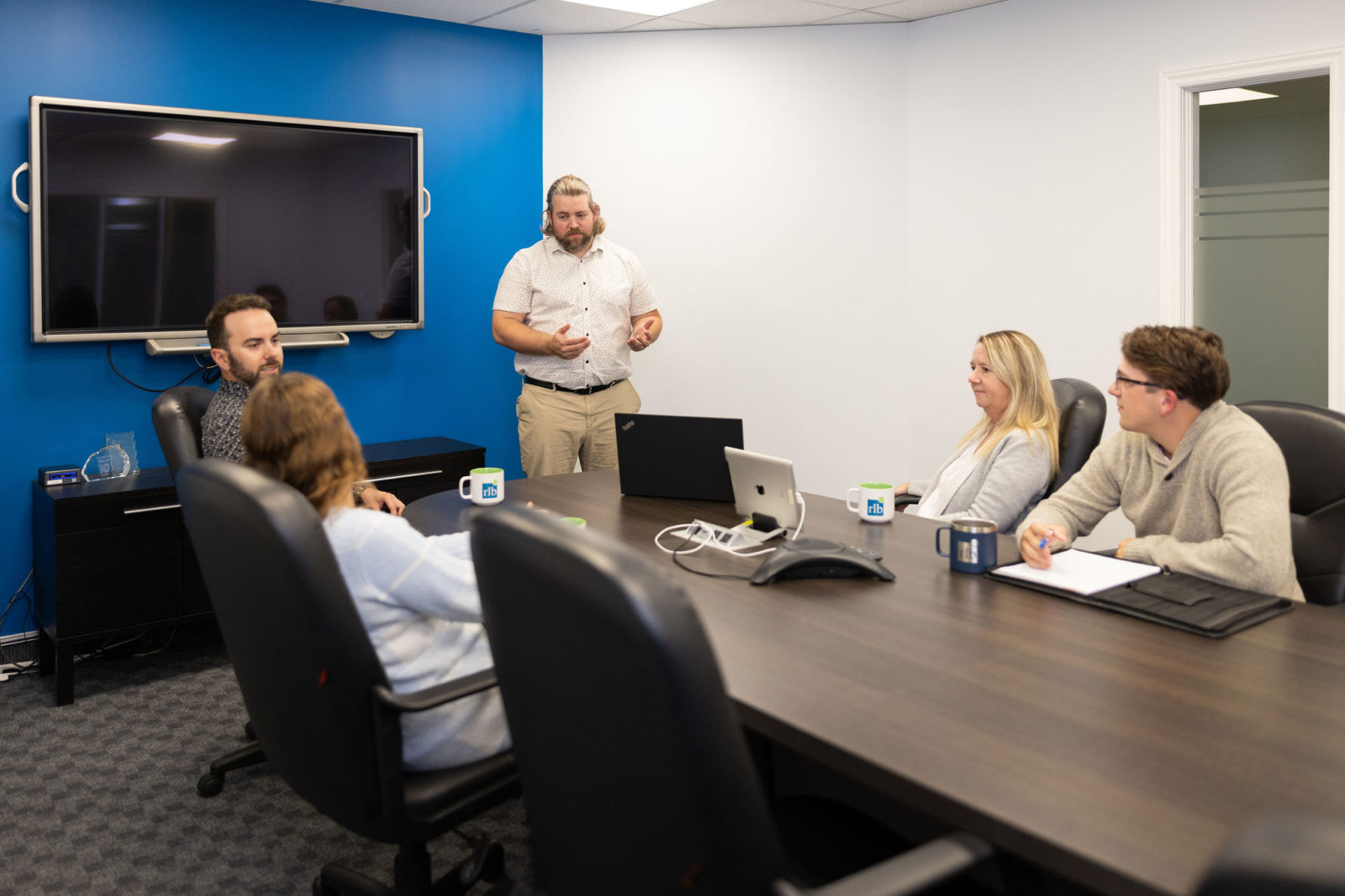 Someone presenting in a meeting room at the RLB Kitchener office.